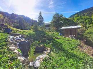 Discover this charming property nestled in a serene, mountainous landscape.