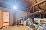 Discover the potential of this spacious attic, featuring exposed wooden beams and a charming rustic aesthetic.