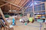 Discover the potential of this spacious attic, featuring exposed wooden beams and ample storage solutions.