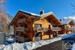 Experience luxury mountain living in this stunning wooden chalet, perfect for a winter getaway.