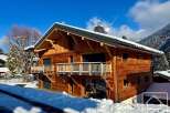 Experience luxury mountain living in this stunning wooden chalet, nestled amidst snow-covered landscapes and majestic peaks.