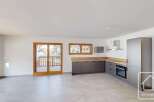 This modern kitchen features sleek, dark grey cabinetry complemented by a light wood countertop.