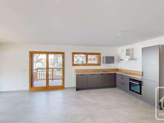 This modern kitchen features sleek, dark grey cabinetry complemented by a light wood countertop.