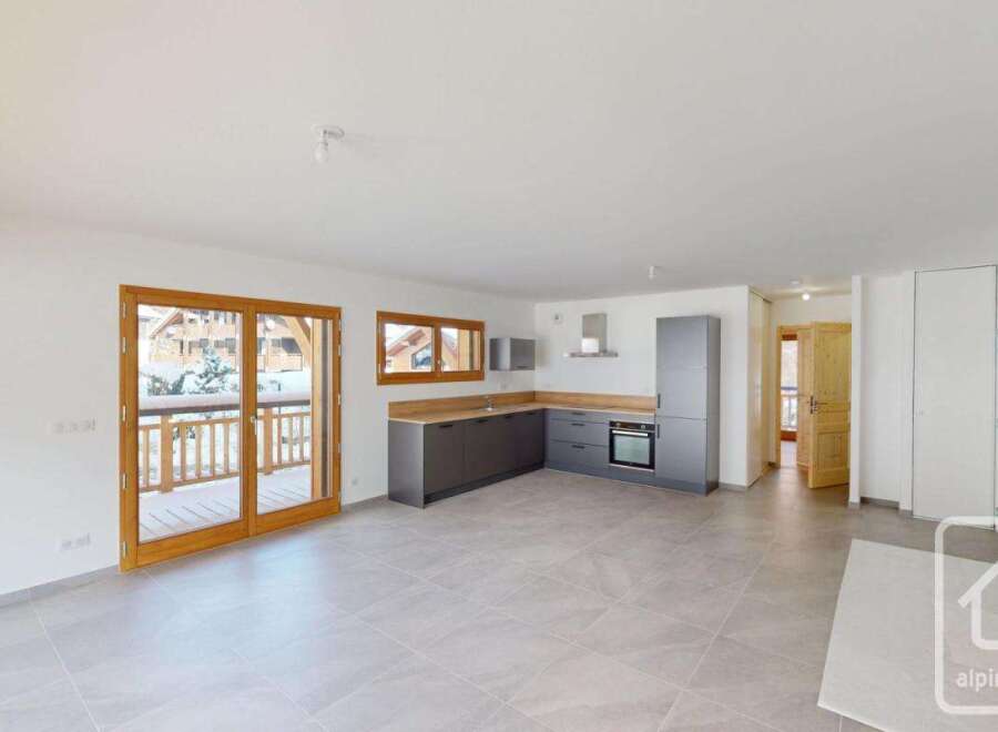 Experience modern living in this spacious open-plan apartment, featuring a sleek, contemporary kitchen with ample counter space and integrated appliances.