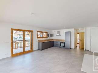 Experience modern living in this spacious open-plan apartment, featuring a sleek, contemporary kitchen with ample counter space and integrated appliances.