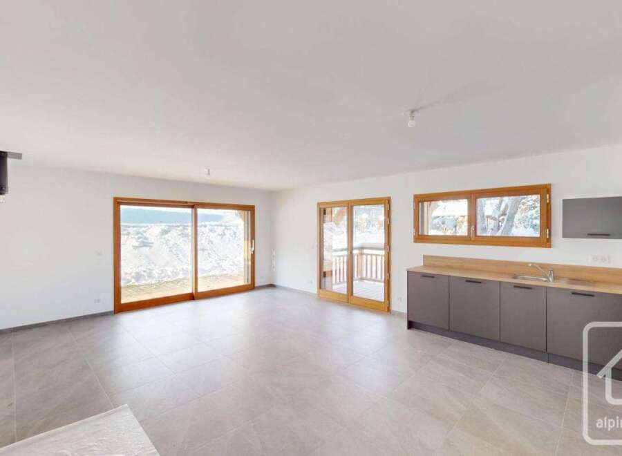 Experience modern living in this spacious open-plan apartment, featuring a sleek kitchen with ample counter space and integrated appliances.