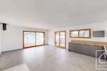 Experience modern living in this spacious open-plan apartment, featuring a sleek kitchen with ample counter space and integrated appliances.