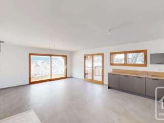 Experience modern living in this spacious open-plan apartment, featuring a sleek kitchen with ample counter space and integrated appliances.