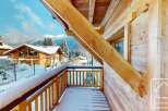 Experience the charm of a winter wonderland from this charming wooden balcony.