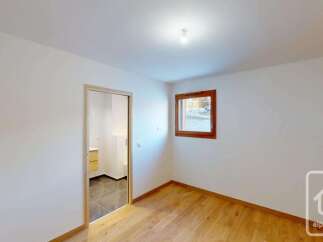 This bright and airy room features a modern interior with clean white walls and a beautiful wooden floor.