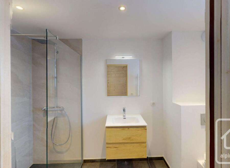 Experience modern comfort in this beautifully appointed bathroom, featuring a spacious walk-in shower with elegant tiling and a sleek glass enclosure.