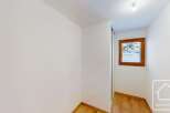 This bright and airy room features a large window offering scenic views of the snowy landscape outside.