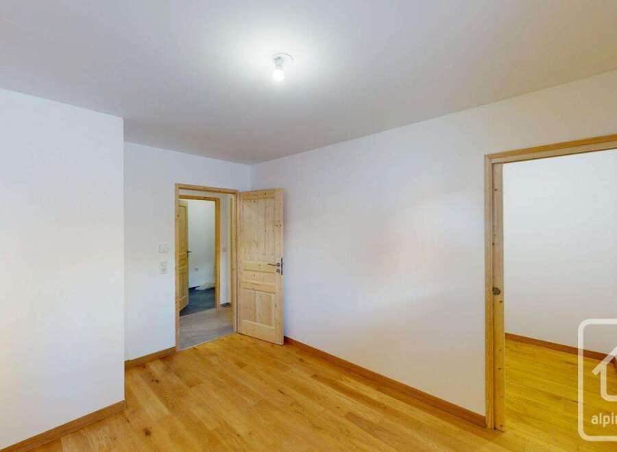 Step into this inviting space featuring gleaming hardwood floors that extend throughout the room, creating a warm and cohesive atmosphere.
