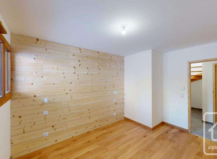 Experience the charm of this alpine property featuring beautifully paneled wood walls and a warm, inviting atmosphere.