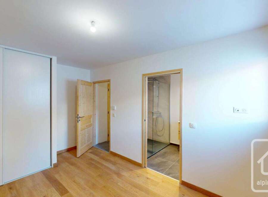This spacious bedroom features a large built-in wardrobe, perfect for ample storage.