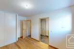 This spacious bedroom features a large built-in wardrobe, perfect for ample storage.