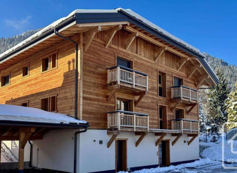 Experience the charm of alpine living in this stunning wooden chalet, nestled amidst snow-covered mountains.