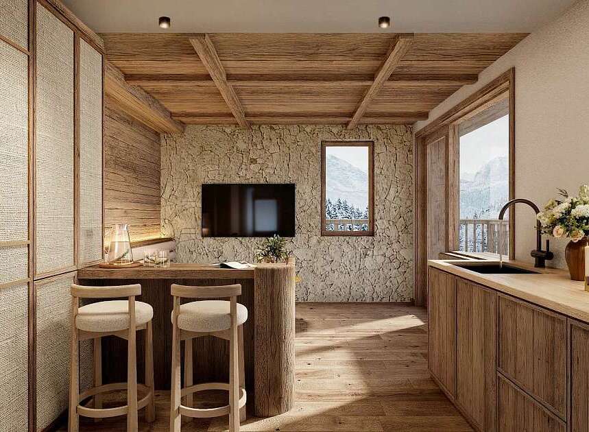 Experience rustic charm in this mountain retreat, featuring a cozy kitchen with natural wood finishes and a stone accent wall.