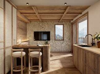 Experience rustic charm in this mountain retreat, featuring a cozy kitchen with natural wood finishes and a stone accent wall.