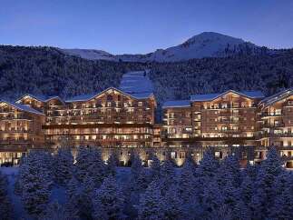 Experience luxury mountain living in this stunning ski resort property, featuring a grand timber-clad architecture that blends seamlessly with the snowy landscape.