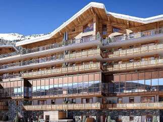 Experience luxury mountain living in this stunning alpine residence, featuring a modern chalet design with extensive use of natural wood and stone.