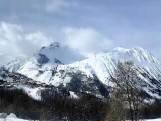 Experience the charm of this picturesque mountain village nestled amidst snow-covered peaks.