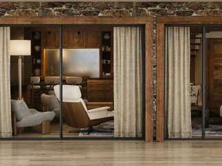 Experience rustic elegance in this stunning home featuring a stone and wood exterior.