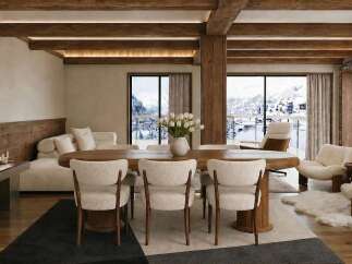 Experience luxurious mountain living in this stunning dining and living area, featuring exposed wooden beams and a stone fireplace.