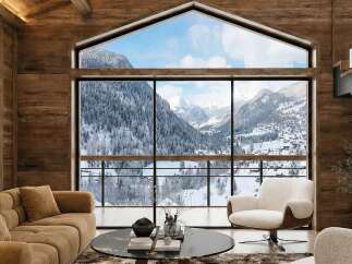 Experience breathtaking mountain views from this stunning chalet-style living room.