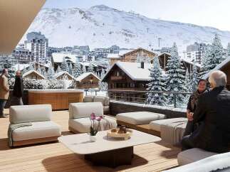Experience luxury mountain living with this stunning ski resort property, featuring a spacious outdoor terrace with a hot tub and breathtaking panoramic views.