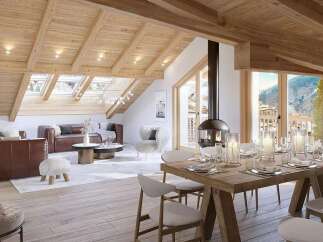Experience luxury mountain living in this stunning attic apartment, featuring a vaulted wooden beam ceiling and expansive skylights that flood the space with natural light.