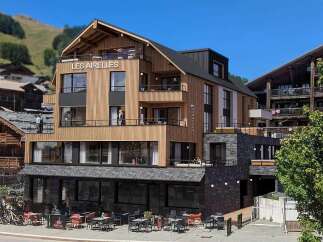 Discover 'Les Airelles,' a stunning modern chalet nestled in a picturesque mountain village.