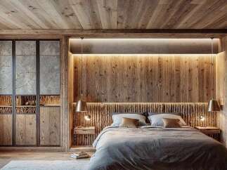 Experience rustic luxury in this master bedroom, featuring a stunning wooden accent wall behind the bed, complemented by warm ambient lighting.