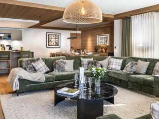 Experience luxury living in this stunning open-concept space, featuring a modern kitchen with sleek cabinetry and a breakfast bar, seamlessly flowing into a spacious living area.