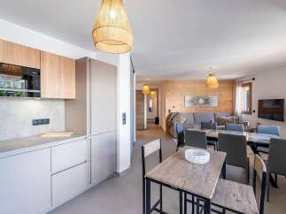 This modern apartment features a sleek, integrated kitchen with a microwave and ample cabinet space, perfect for preparing meals.