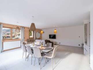 Experience modern living in this spacious open-plan dining and living area, featuring a large dining table perfect for family gatherings.