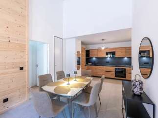 Experience modern living in this stunning apartment featuring a spacious dining area with a contemporary table and chairs, perfect for family meals.