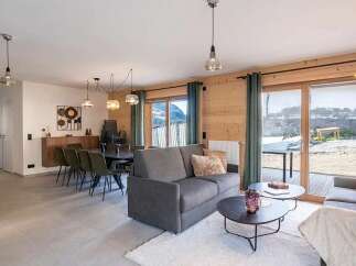Experience modern living in this spacious open-plan apartment, featuring a comfortable living area with plush seating and a stylish dining space perfect for entertaining.