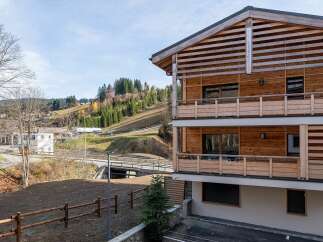 Experience modern alpine living in this stunning wooden chalet, featuring multiple balconies with scenic mountain views.