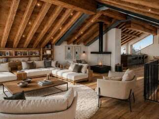 Experience luxurious mountain living in this stunning chalet, featuring a spacious open-concept living area with a modern fireplace and floor-to-ceiling windows offering breathtaking alpine views.