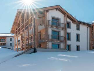 Experience modern alpine living in this stunning property featuring a contemporary design with warm wooden accents and expansive balconies.