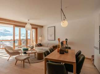 Experience breathtaking mountain views from this stunning living and dining area, featuring a cozy seating arrangement and a spacious dining table perfect for entertaining.