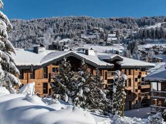 Experience luxury mountain living in this stunning chalet-style property, nestled amidst a picturesque snow-covered landscape.