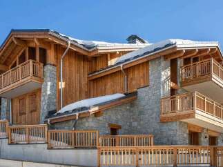 Experience luxury mountain living in this stunning chalet, featuring a harmonious blend of natural wood and stone architecture.