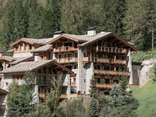 Experience luxury mountain living in this stunning chalet-style property, nestled amidst a serene forest landscape.