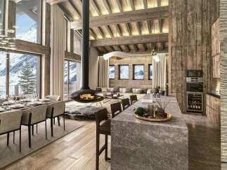 Experience luxury mountain living in this stunning chalet featuring a grand open-plan living area with a suspended fireplace and breathtaking panoramic views of snow-capped peaks.