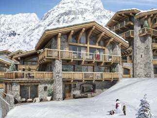 Experience luxury mountain living in this stunning chalet, featuring exquisite stone and timber architecture.