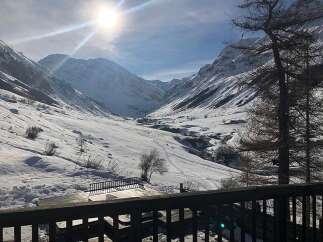 Experience breathtaking mountain views from this stunning property, nestled in a serene, snow-covered valley.