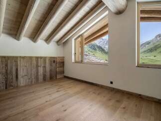 Experience rustic charm and breathtaking mountain views from this attic room.