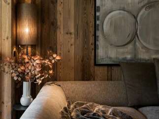 Experience rustic elegance in this cozy living space, featuring warm, natural wood paneling on the walls and ceiling.